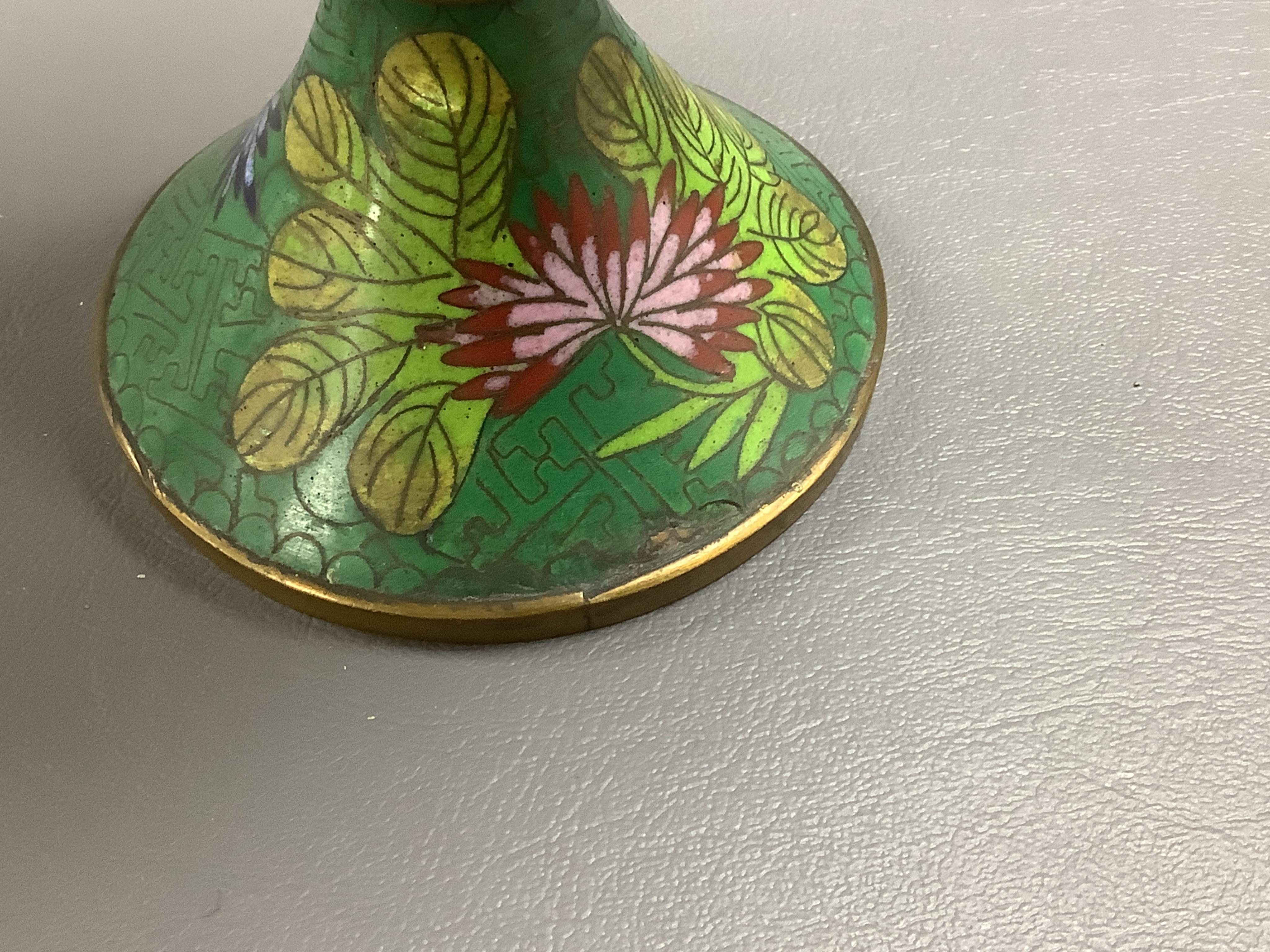 A pair of Chinese champleve enamel floral jars and covers, 22cm high. Condition - good